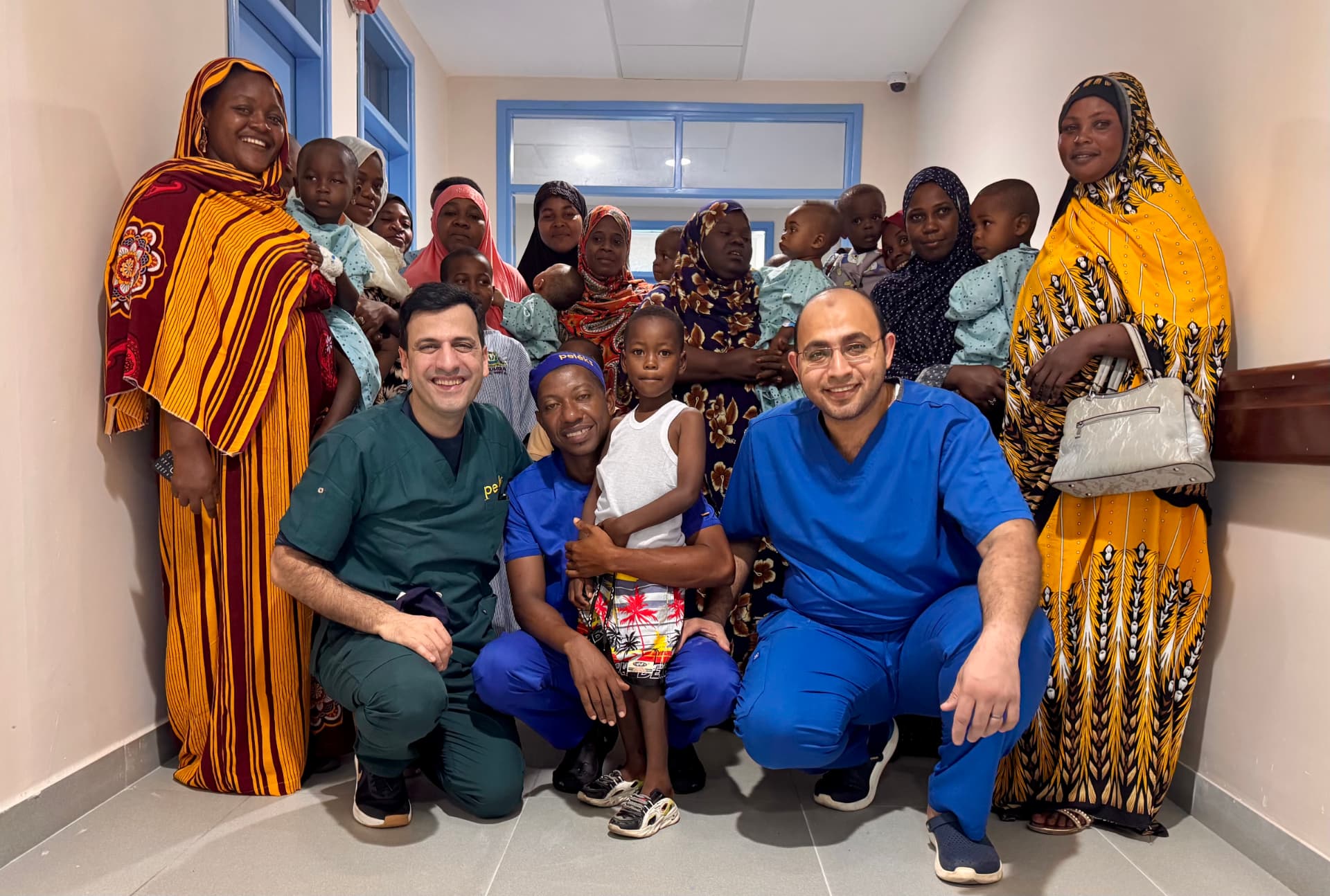 Dr. Farhan with local medical team and families during a humanitarian surgical mission