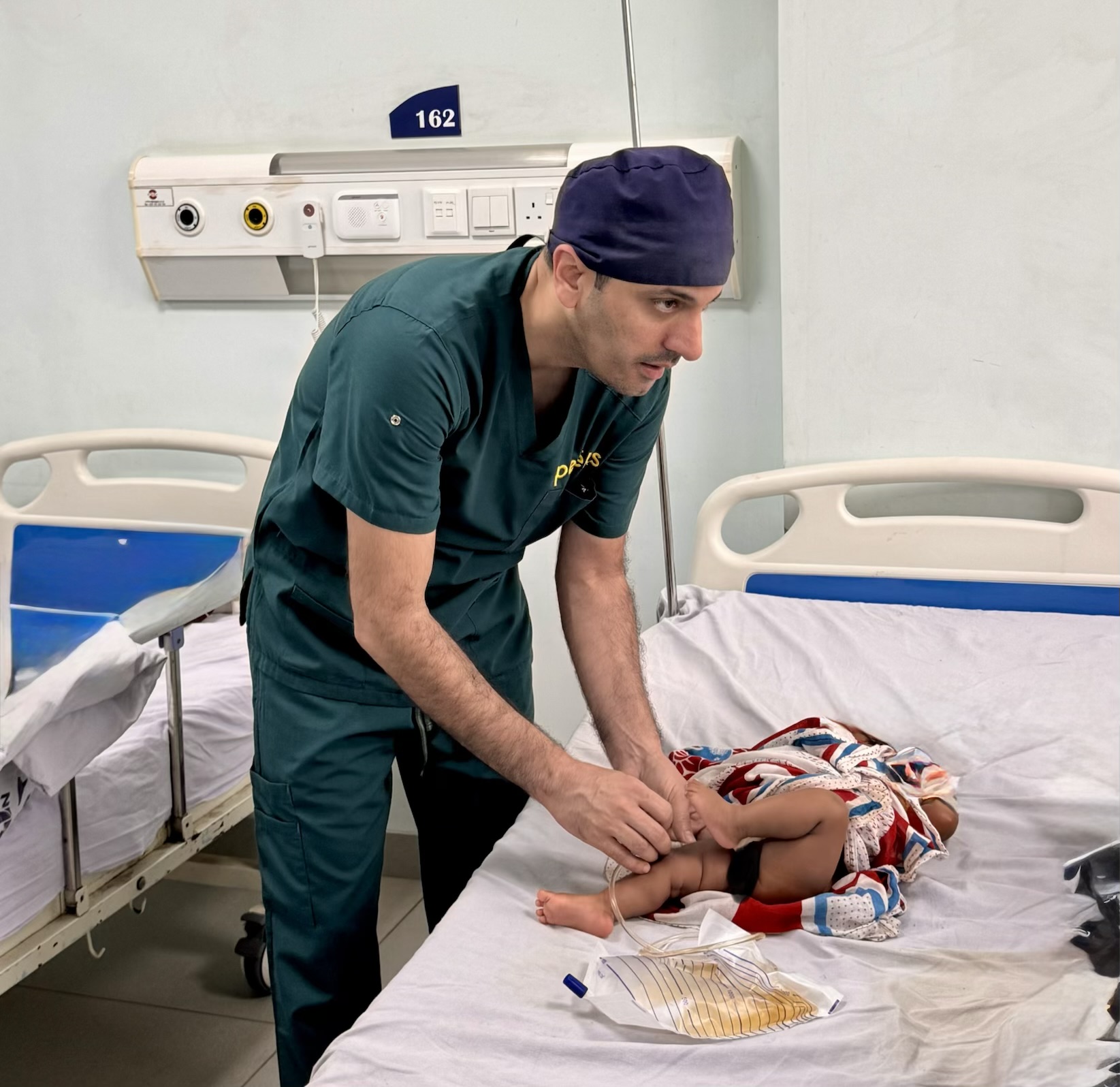 Dr. Farhan providing postoperative care to a young patient