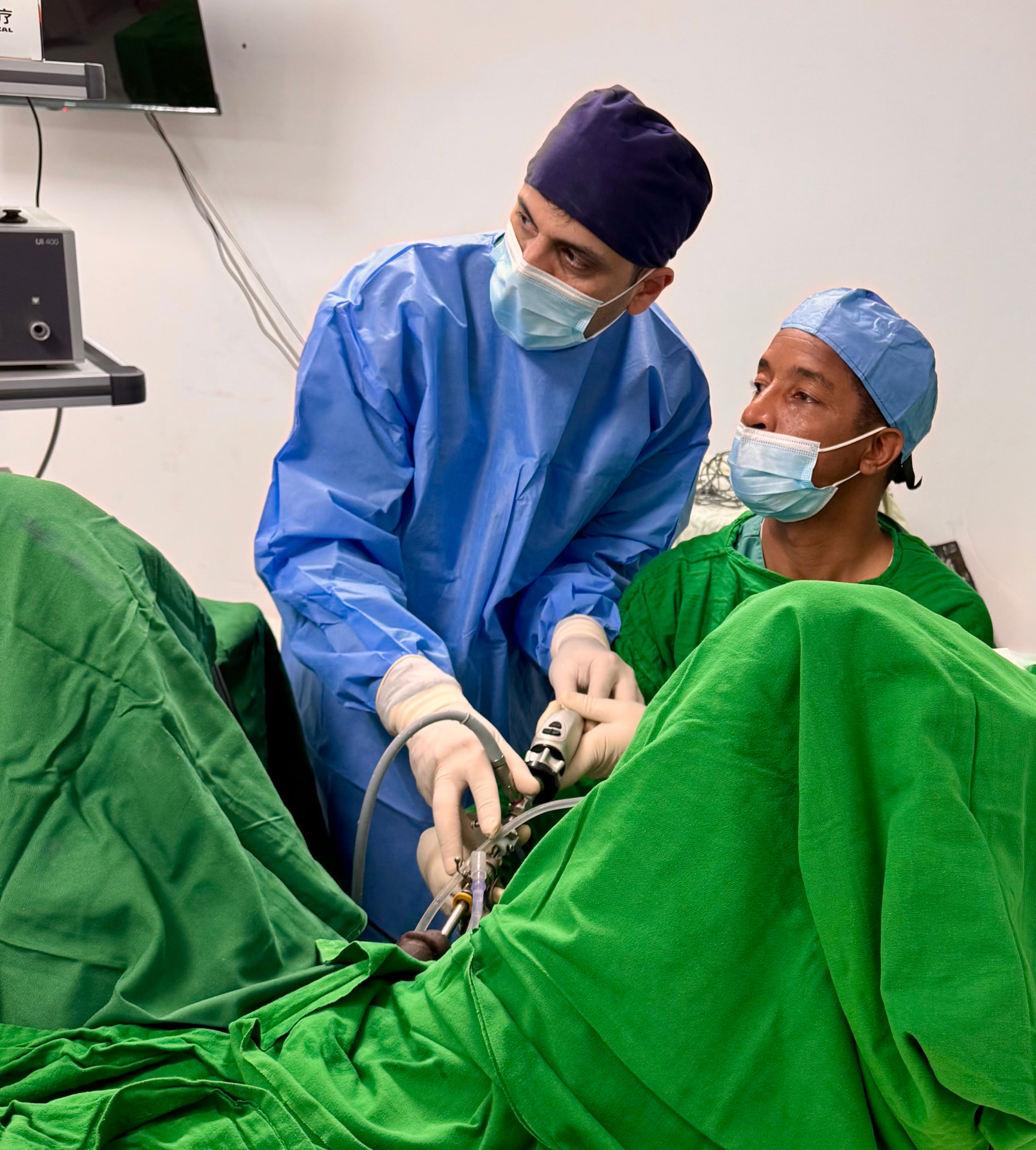 Dr. Farhan operating with a local surgeon during a humanitarian mission
